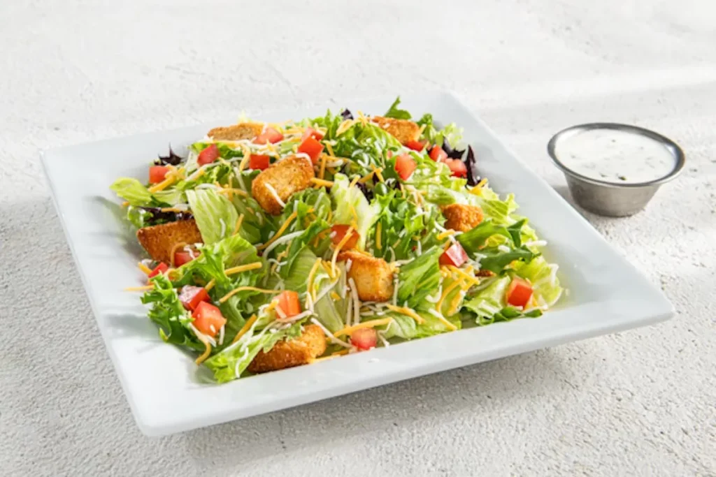 Side House Salad Ingredients: Grilled ChickenBlack Beans, Sweet Corn, Shredded Cheese, Diced Tomatoes, Crispy Tortilla Strips, Chopped Cilantro for freshness, Creamy Chipotle Dressing Price: $6.69 Calories: 270-380 Cal
