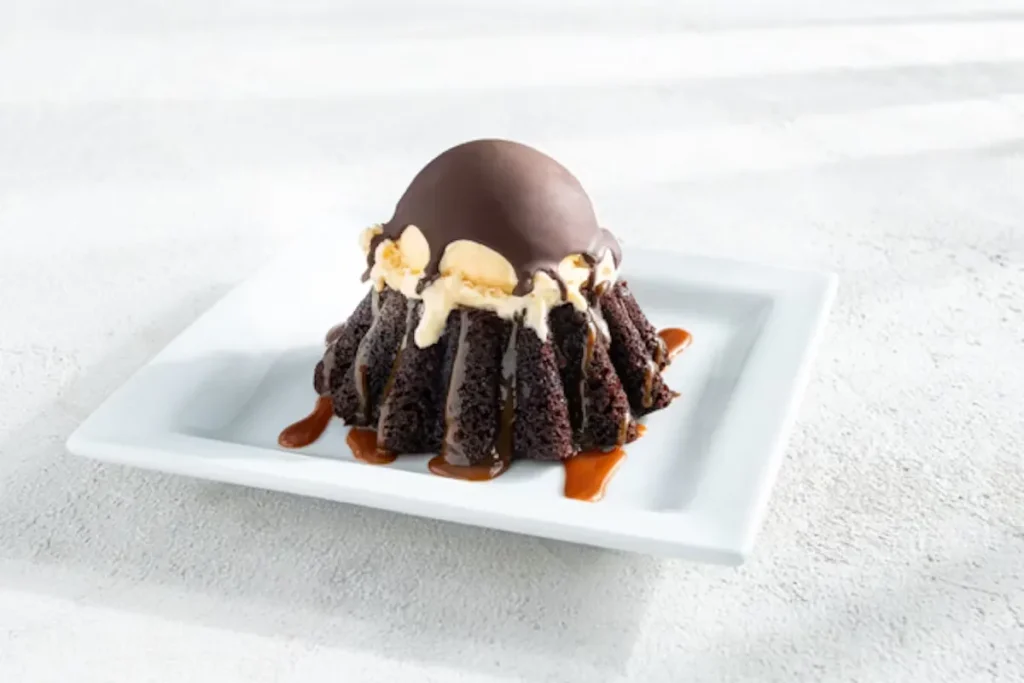 Molten Chocolate Cake Ingredients: Warm chocolate cake, Molten fudge center, Vanilla ice cream, Chocolate shell topping, Caramel drizzle Price: $9.89 Calories: 1170 Cal